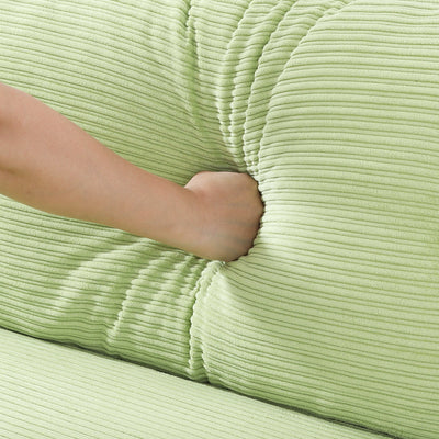 The 53-inch green sofa offers a spacious layout in the small apartment, easily handling various scenarios from watching movies to working